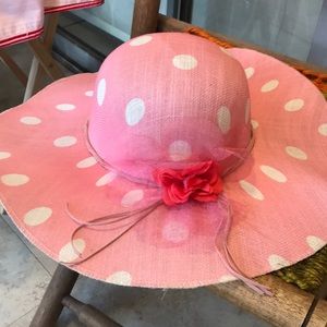 A pink with white poco dot beach hat